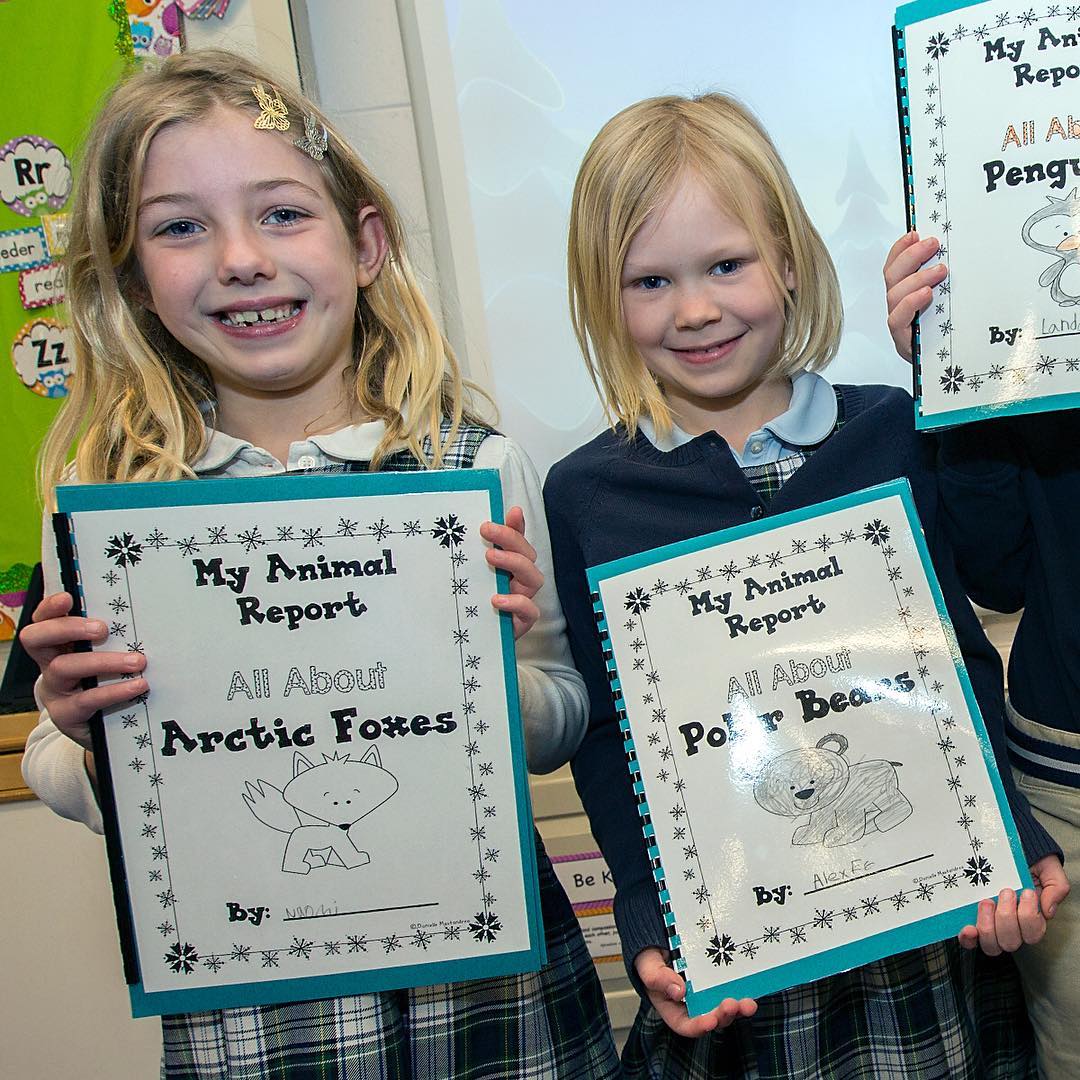Proud first-graders show off their report books from the class Arctic Project