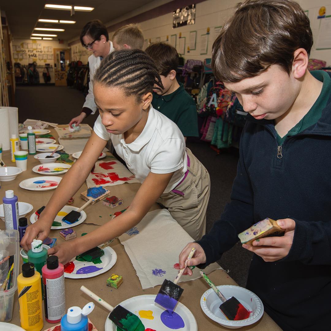 Students work on making hand painted place mats that will adorn the table at the upcoming fourth-grade Colonial Day celebration, the week after Easter
