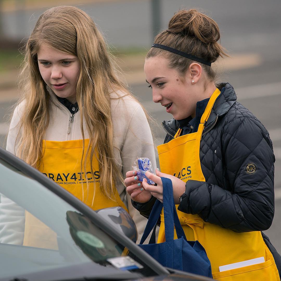 Students and parent volunteers handed out Week Two prayer sheets to folks in car pool line Monday afternoon, encouraging them to pray as they spend time in the car