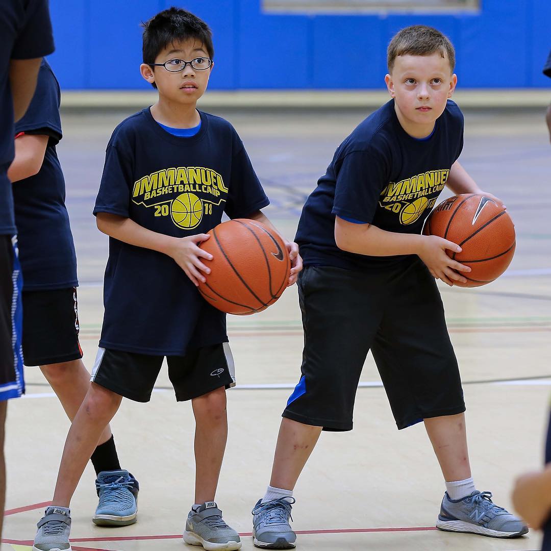 Kids follow instructions during a ball-handling drill at the annual Warrior Basketball Camp