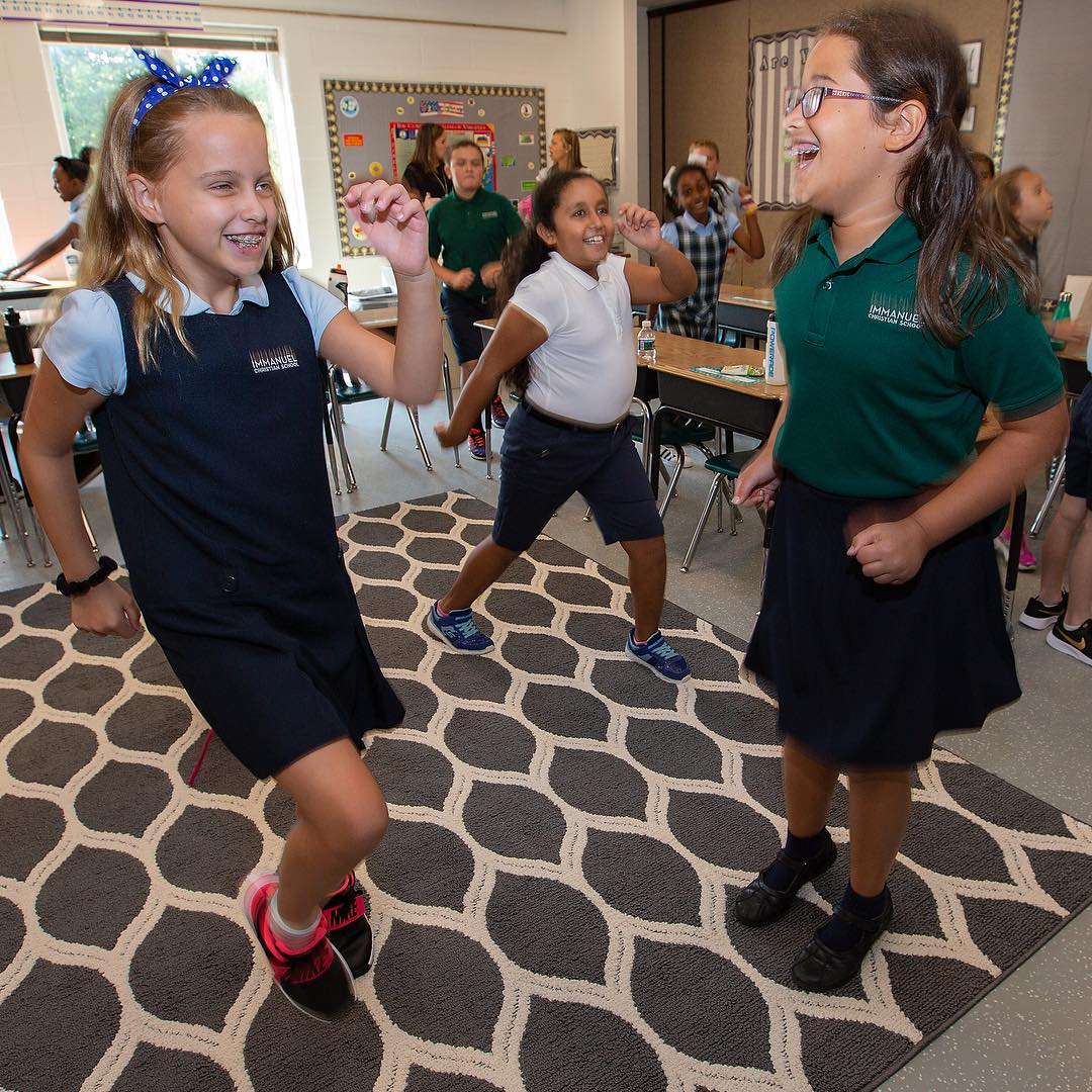 Students enjoy an exercise activity during their first day back to school at